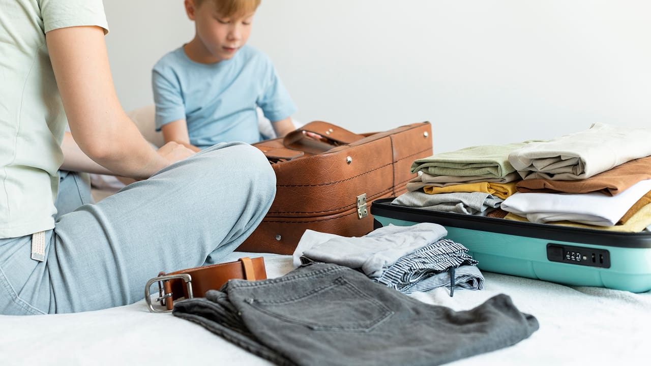 A mother and son packing together for a trip
