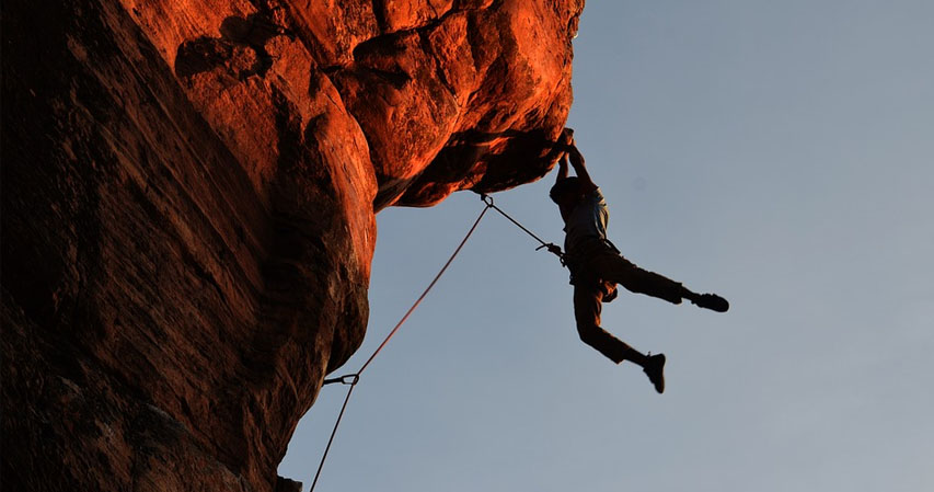 Climber hanging a hundred feet high