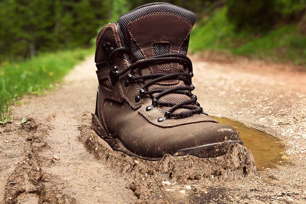 hiking on a mud trail while wearing boots