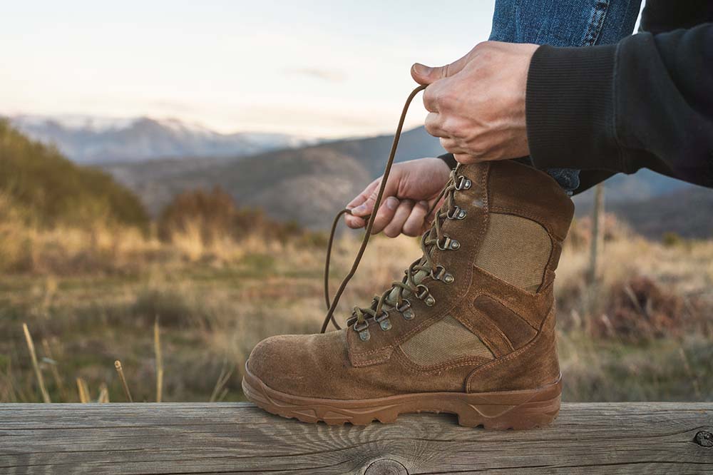 tying the shoe lace knot up on the hill