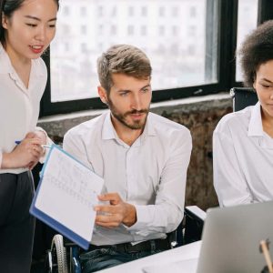 Group Wearing Employee Uniforms in Front of Laptop
