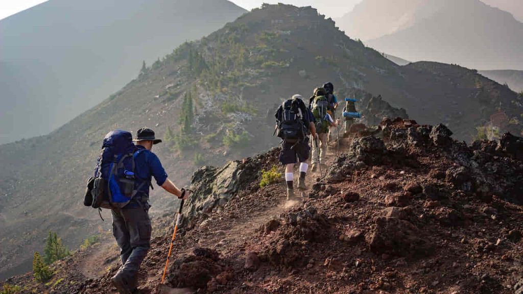 group of people climbing up the mountain