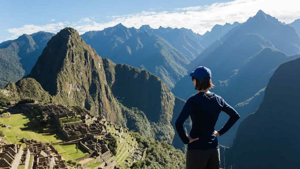 woman enjoying the scenic view at the top of mountain