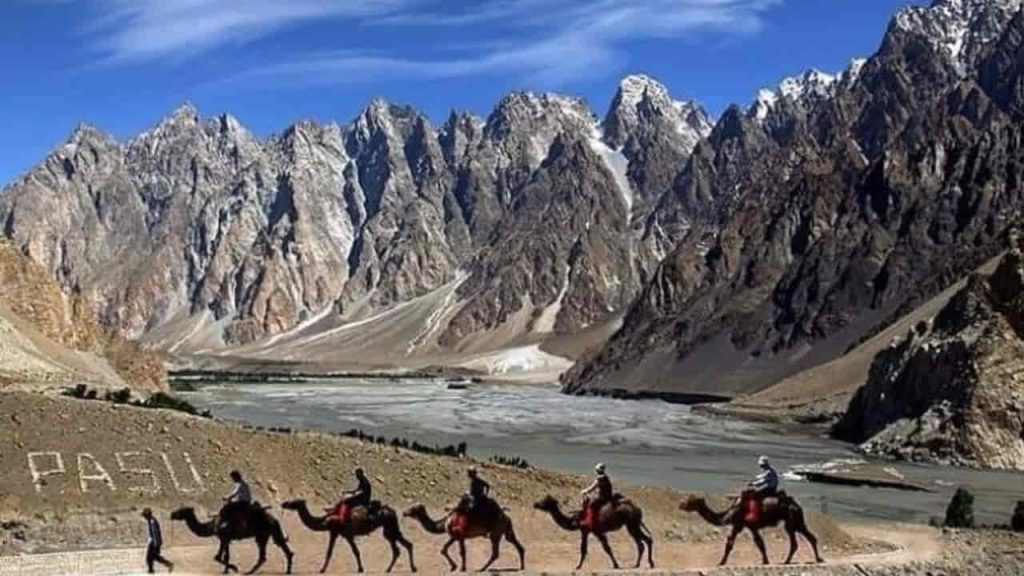 people riding on camels in passu cones