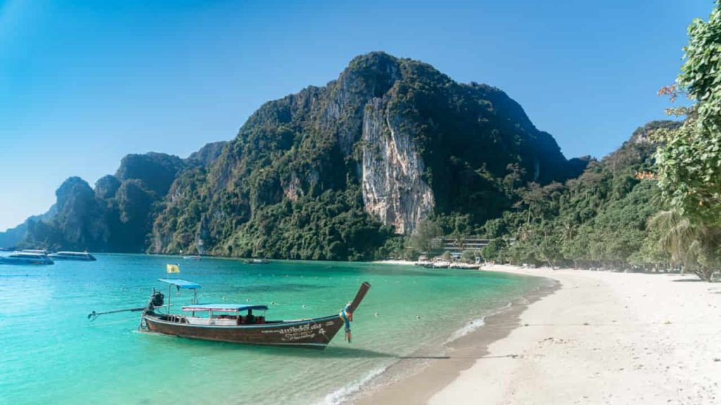 mountainous view with boat in the ocean