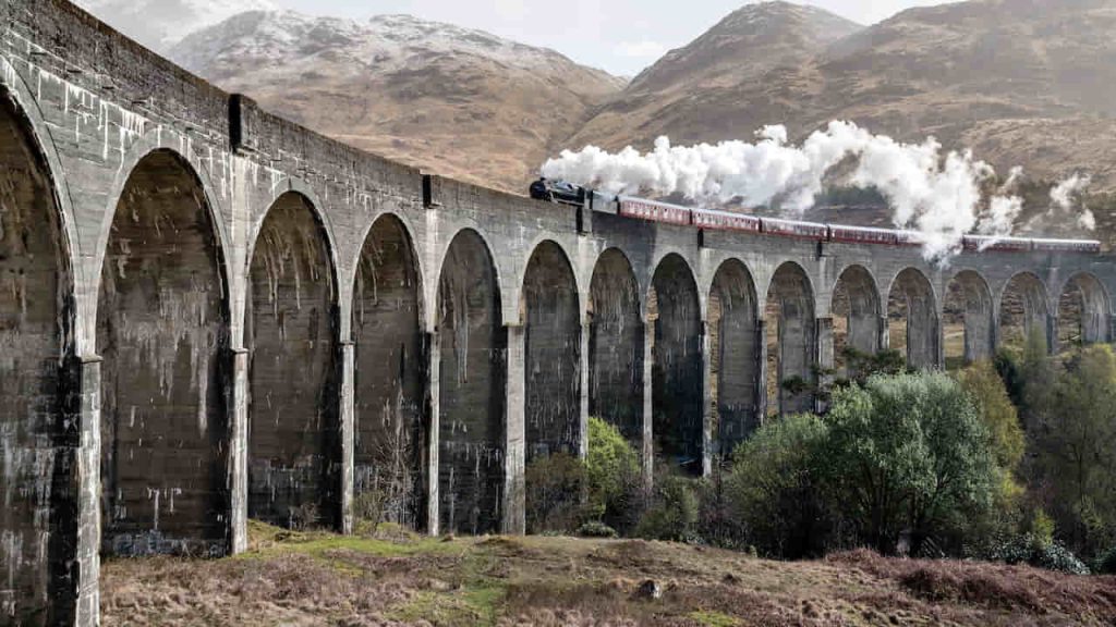 train with smoke on the bridge