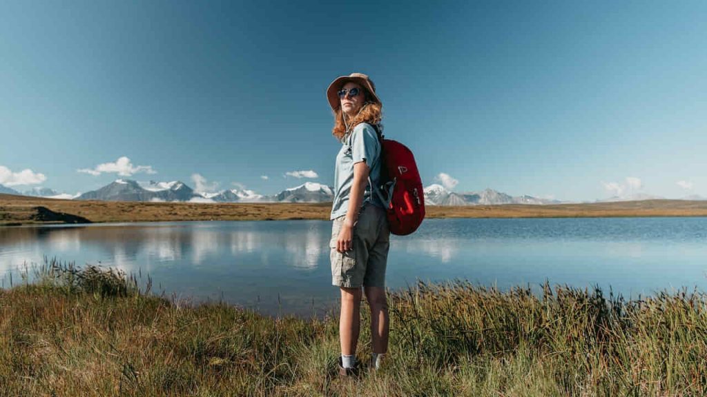 woman standing with travel gear