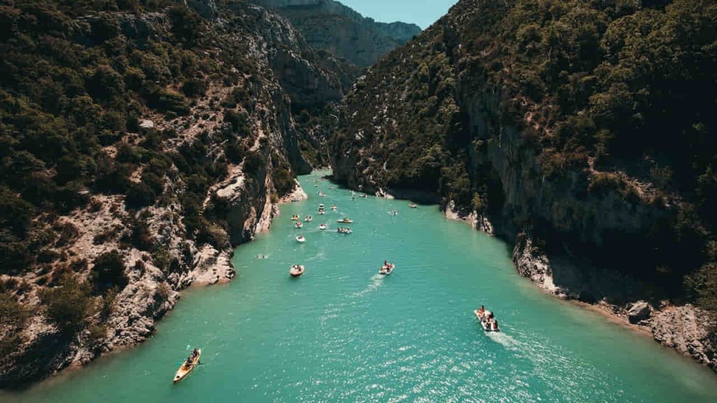 Photo of People Riding Kayaks Near Mountains
