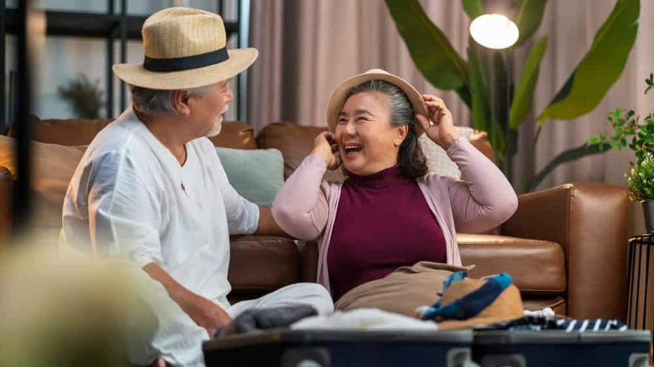 Happy Elderly Couple Packing for Vacation