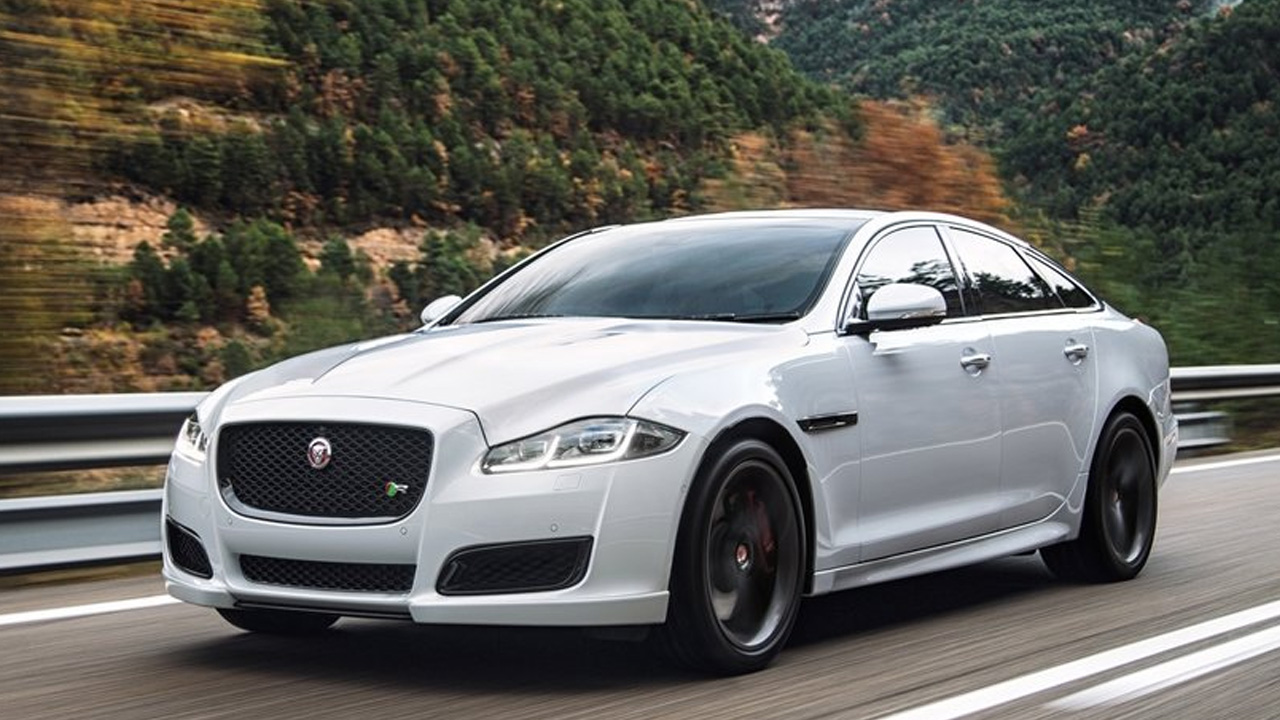 Jaguar XJ in white is showing luxury on a mountainous road