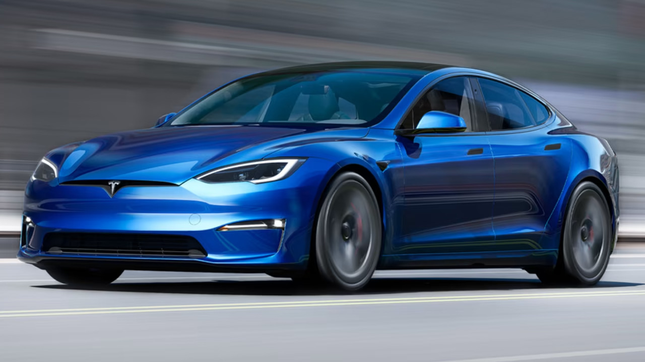 a metalic blue Tesla Model S is running on the track