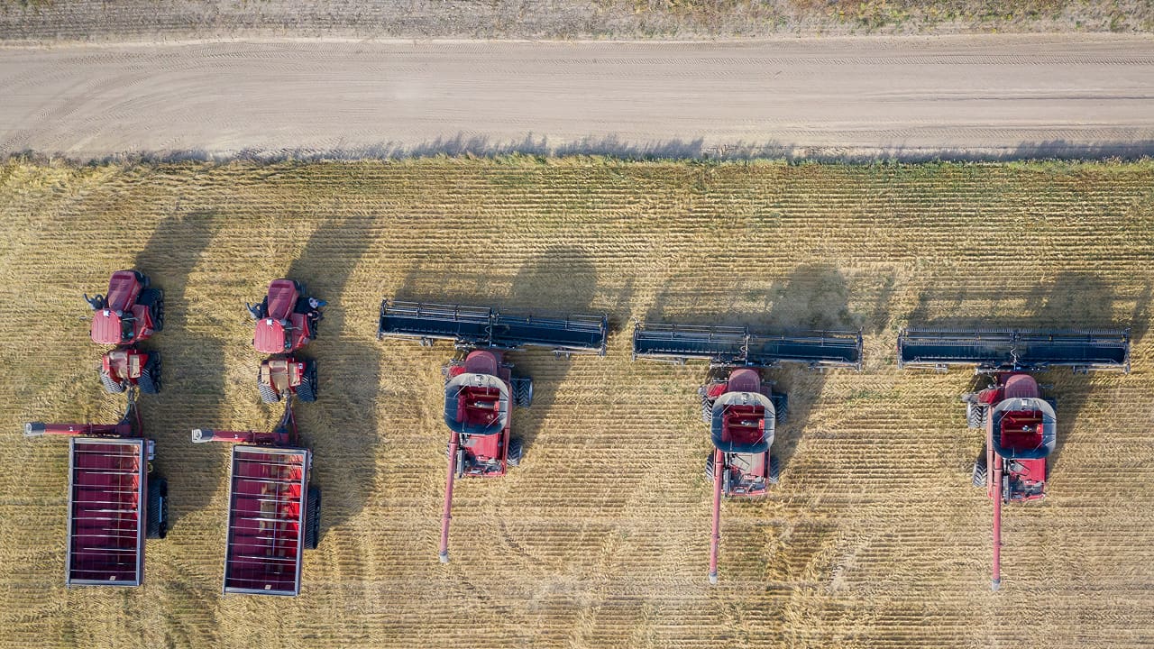 Upper view of a group of harvesters in a farming field