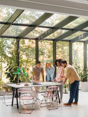 A group of people is discussing the construction of a sunroom.