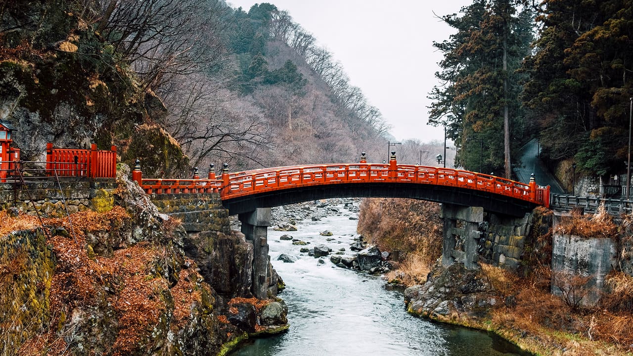A stunning view of a red bridge in Japan, one of the best honeymoon destinations.