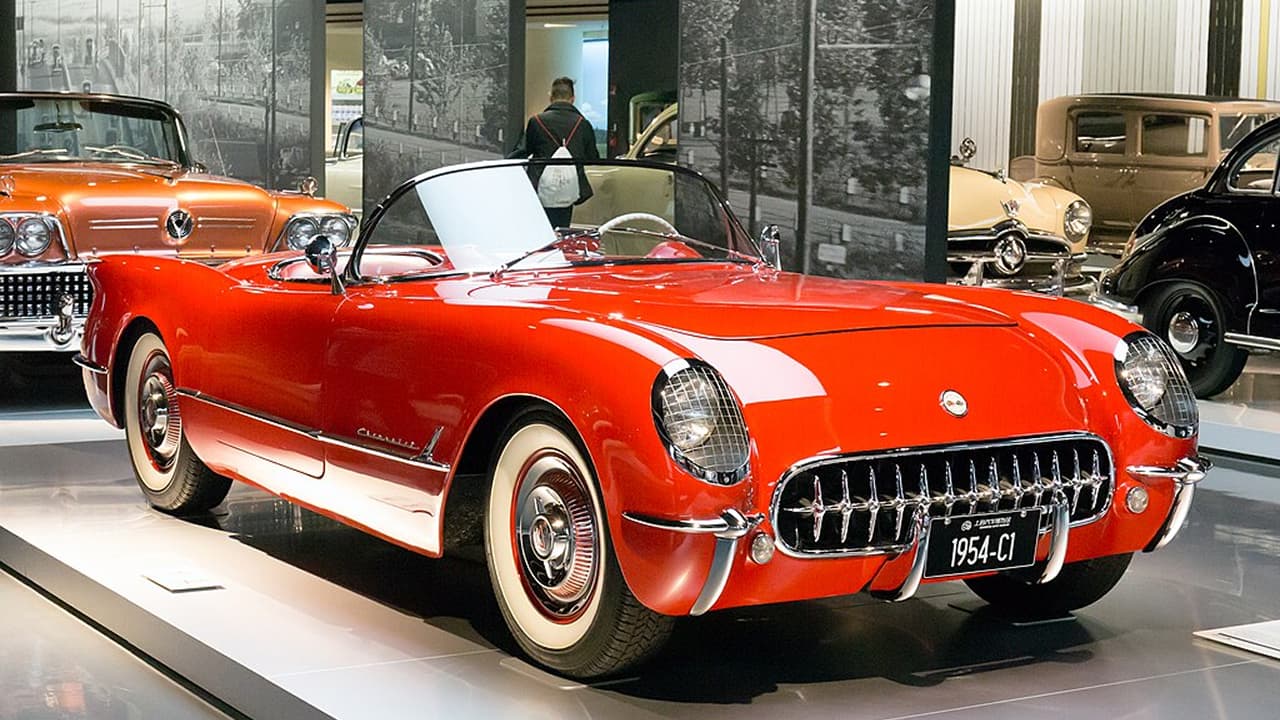 A red Chevrolet Corvette C1 displayed in a showroom
