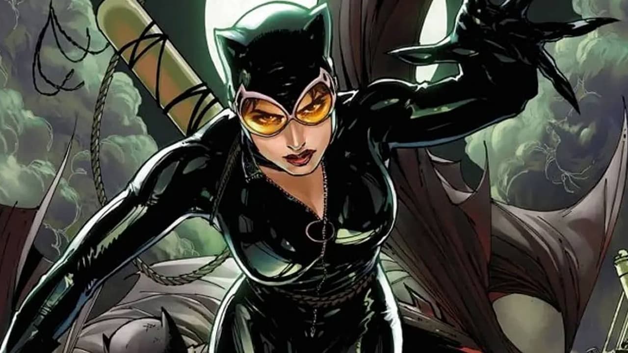 Catwoman is moving forward and trying to grab something