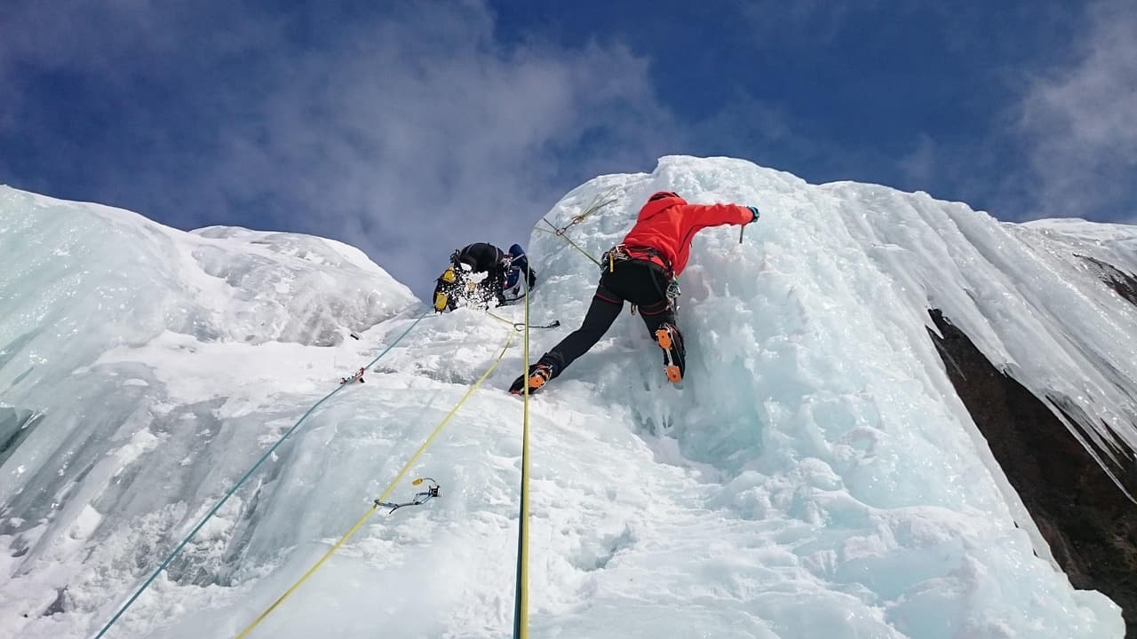 Two people are climbing an ice mountain