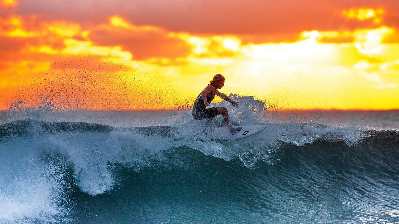 Man surfing on waves which is the extreme sport