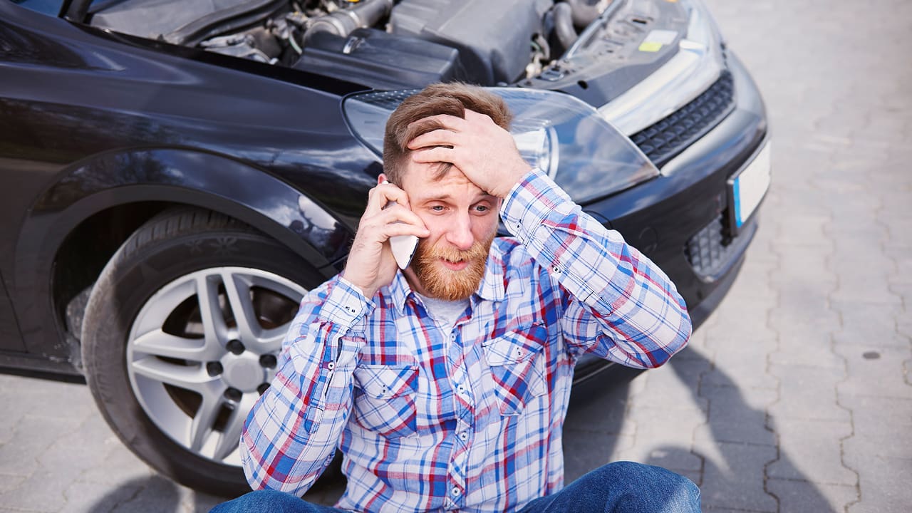 A man is having trouble with his car