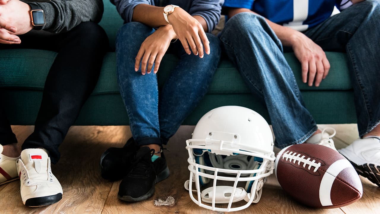 Three friends cheering together for their sports league after getting sports insurance