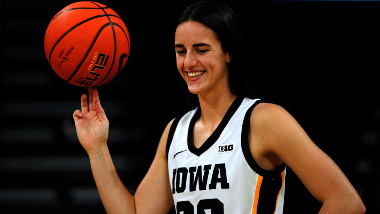 Caitlin Clark skillfully dribbles a basketball with her fingers