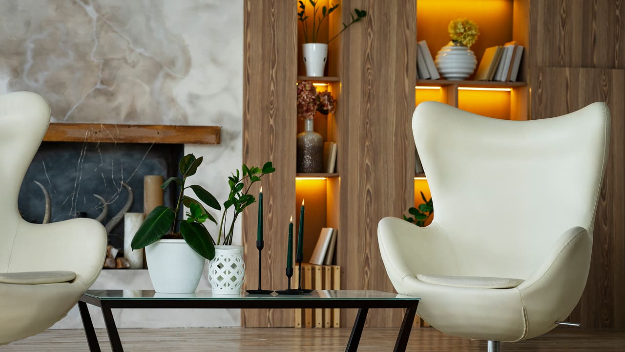 Designing the interior of a room with an armchair and plants is an important step for your summer rental home
