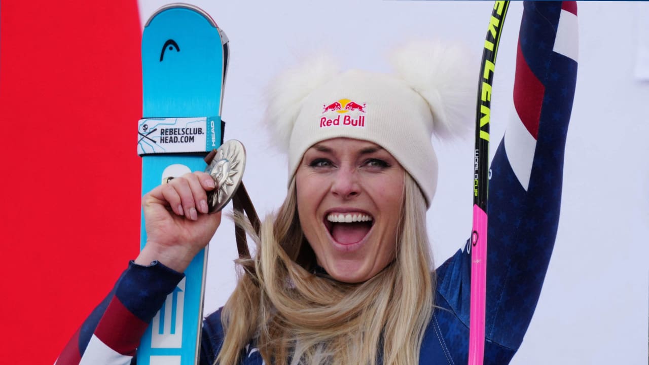 Lindsey Vonn is smiling and proudly showing off her medal
