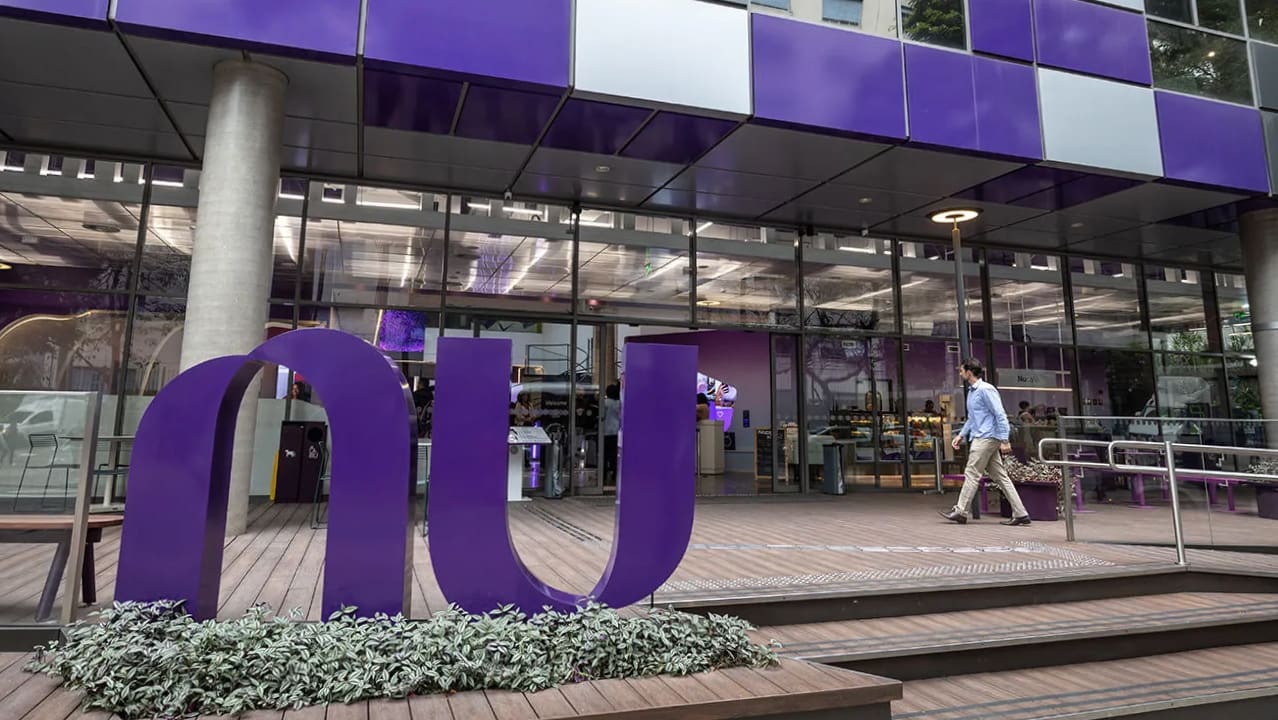 A view of the exterior of Nubank, showing a man entering the building