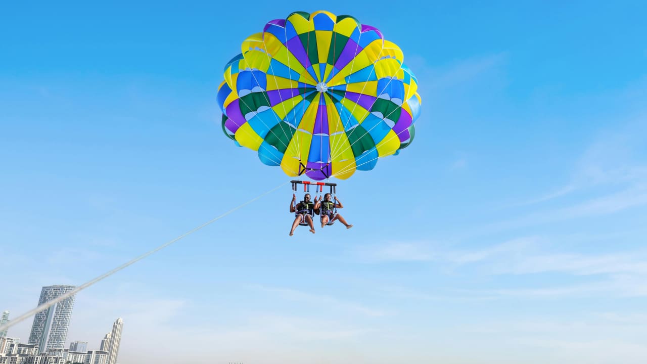 A couple doing parasailing