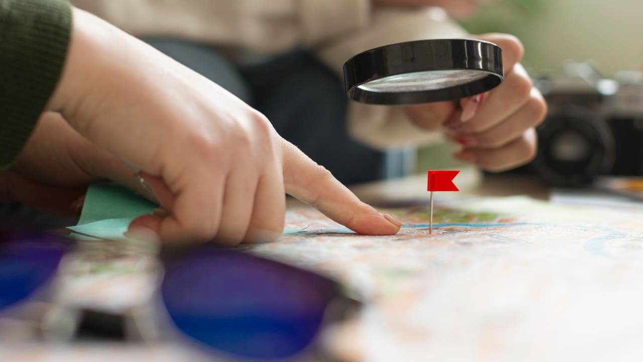Close up of a hand holding a magnifying glass