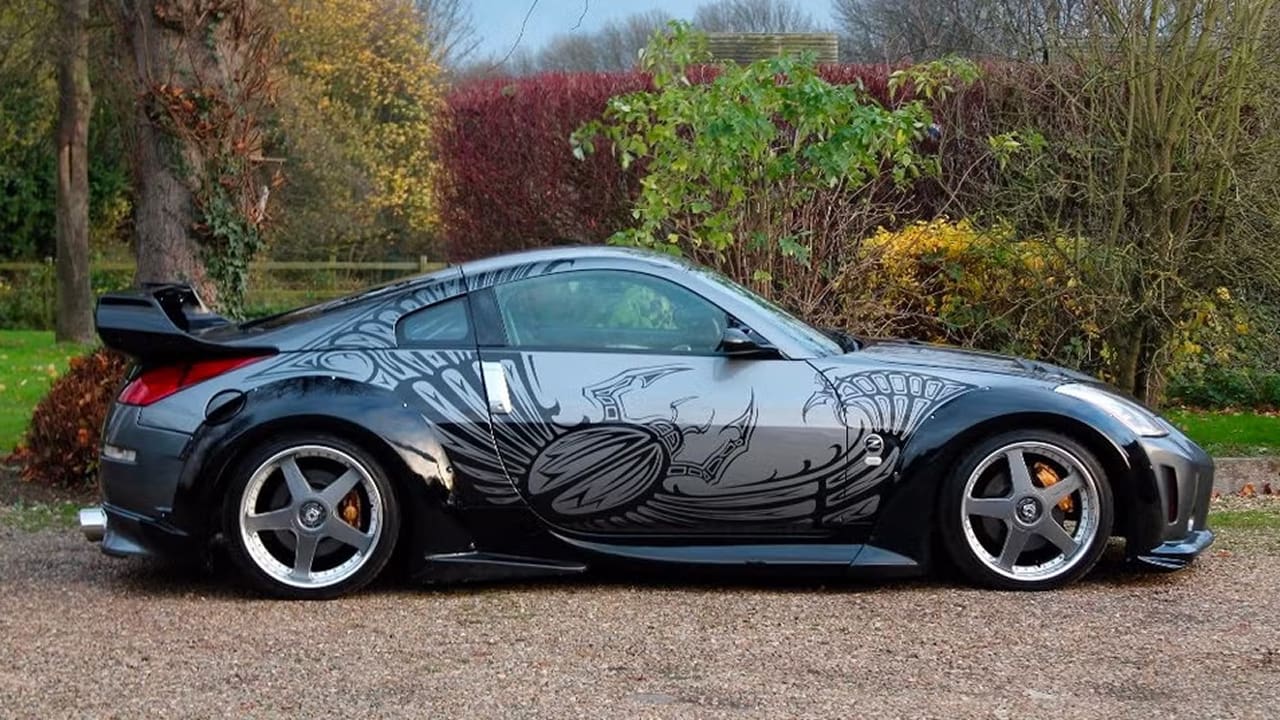 A patterned Tokyo drift car is parked by the roadside