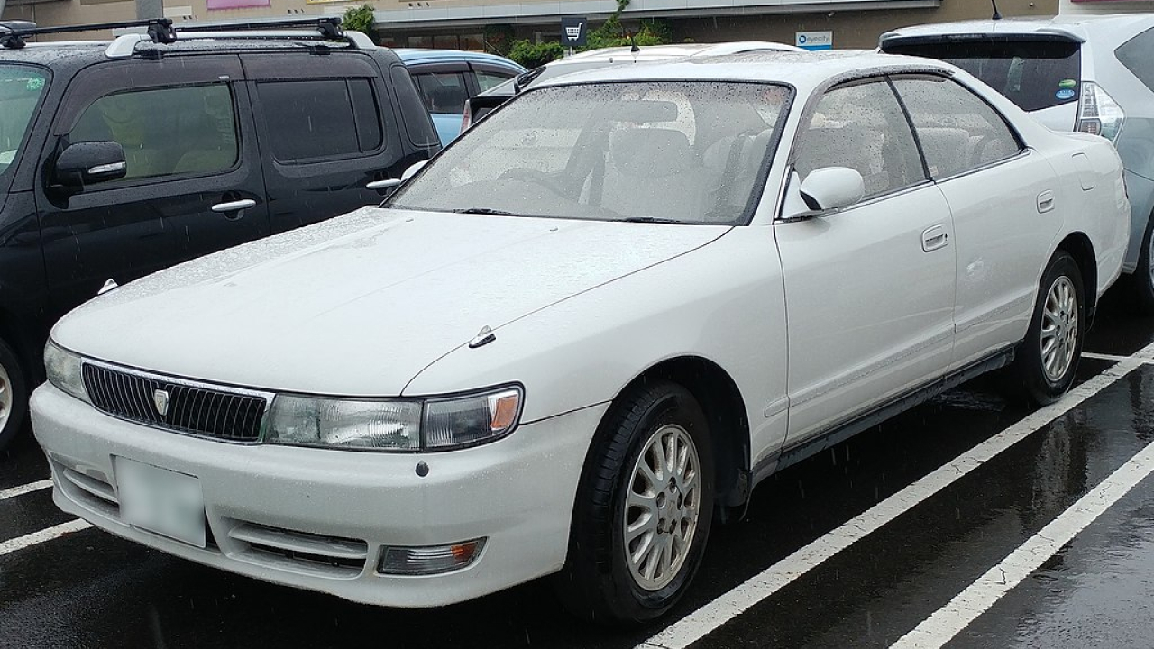 A white toyota chaser parked