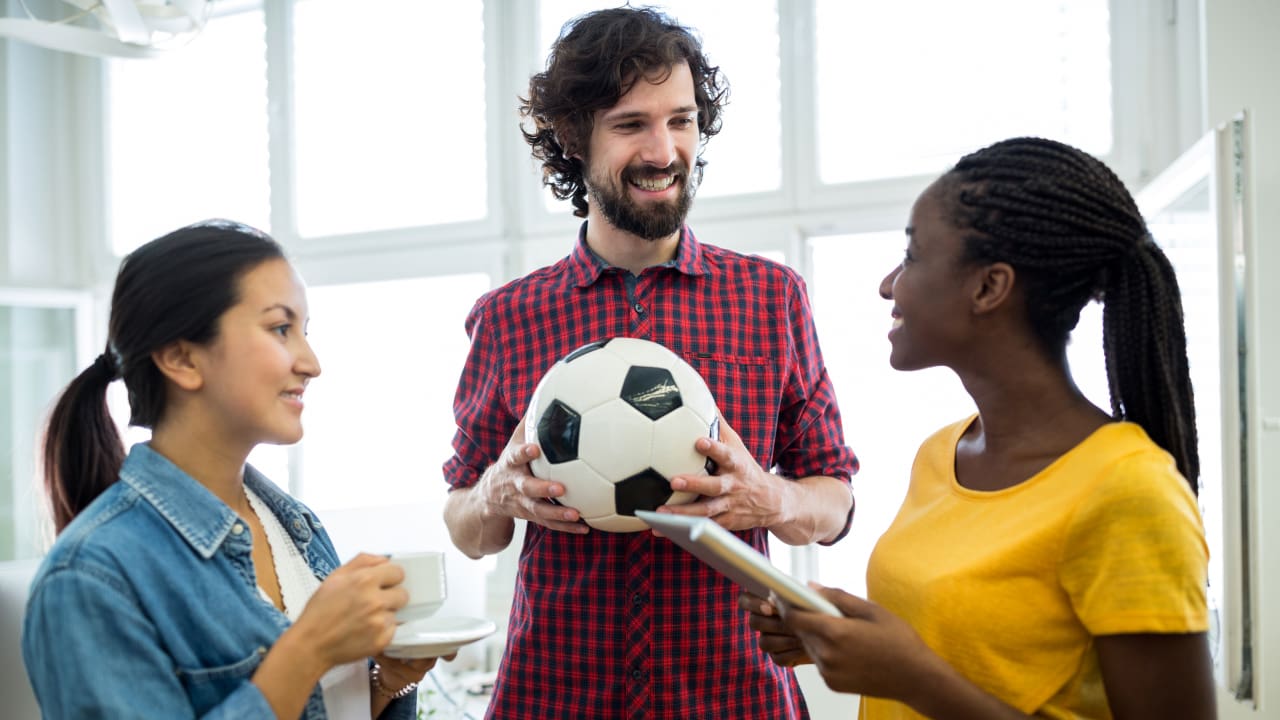 Three friends discussing about sports insurance