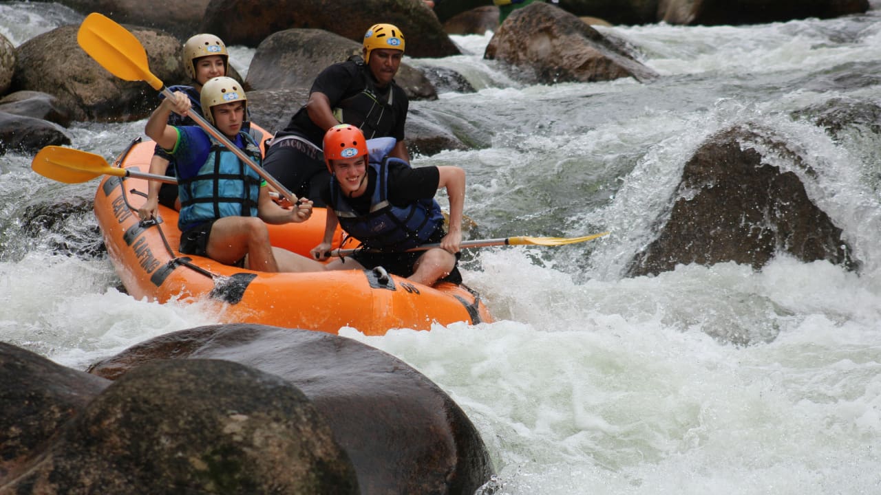 A group of people doing white water rafting adventure