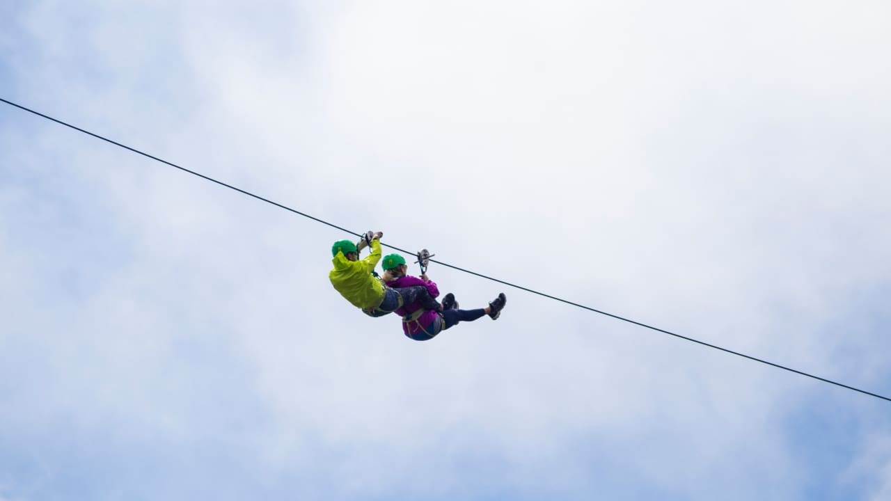 Adventurous tourist zip lining