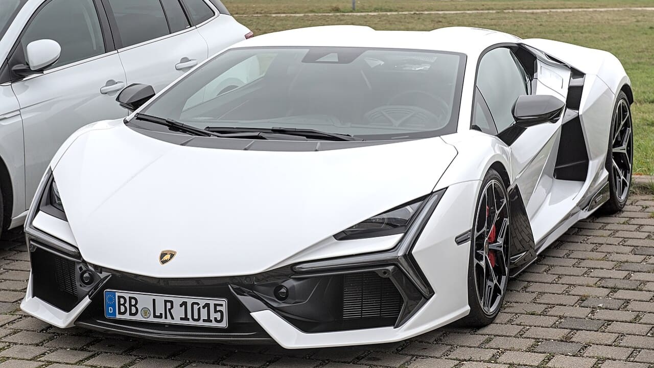 A white Lamborghini parked on a roadside