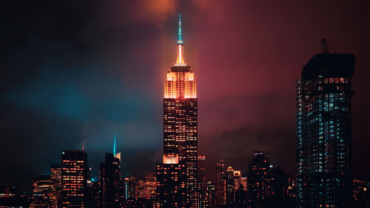 A New York City building illuminated at night serves as a hub for fintech startups