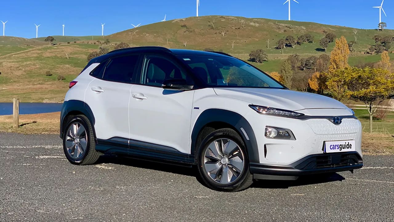 The Hyundai Kona Electric is positioned against a stunning view