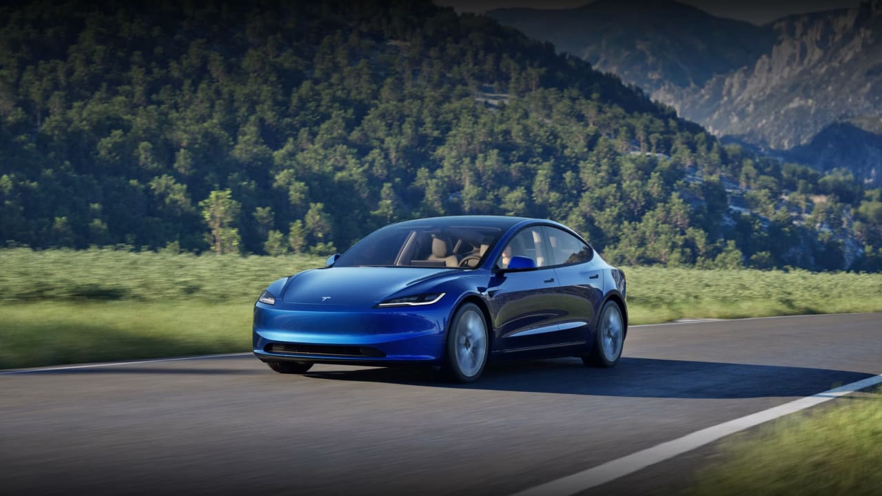 A Tesla Model 3 is crossing the road, it is one of the least expensive electric cars