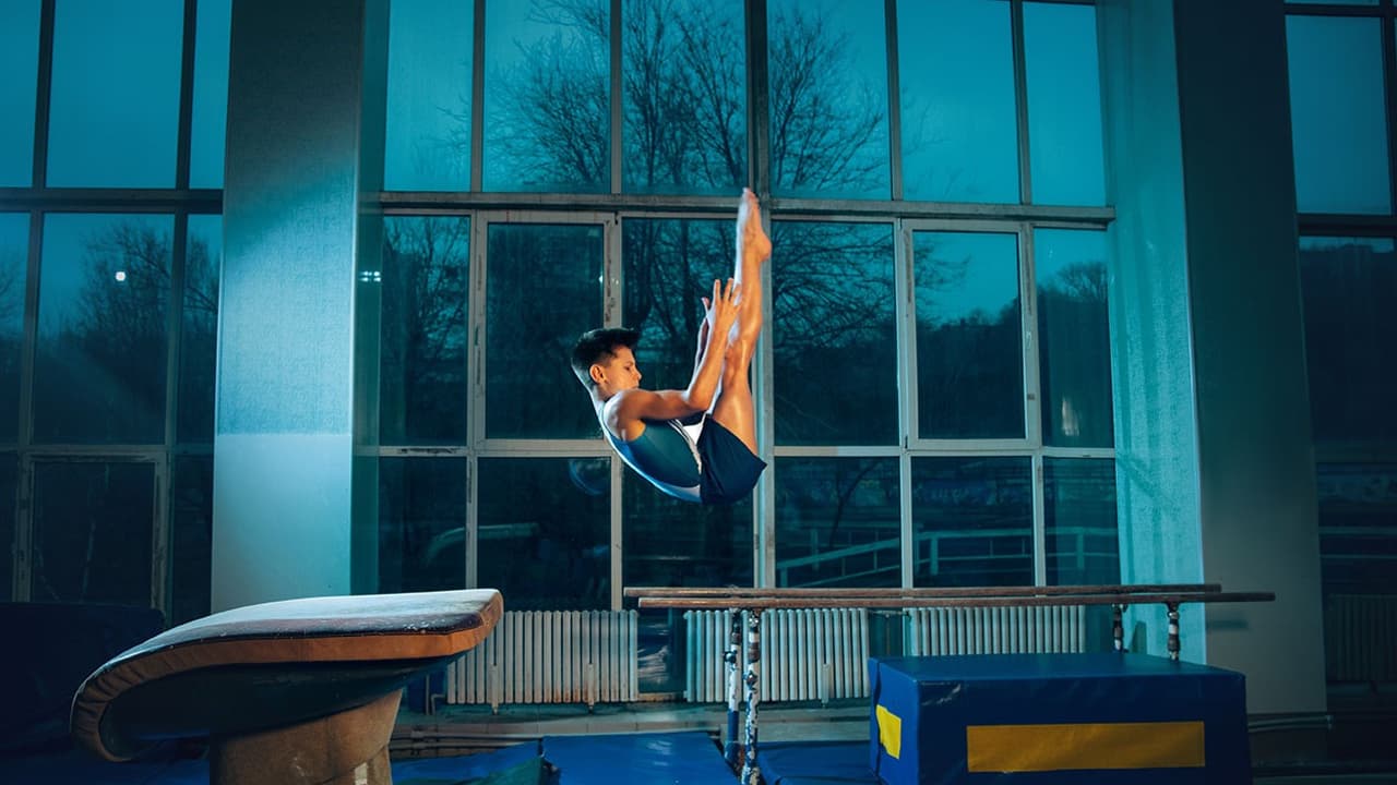 a male gymnast's capture in the air while doing flip jump