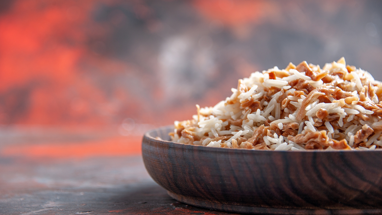 This is a front view of cooked arborio rice in a bowl
