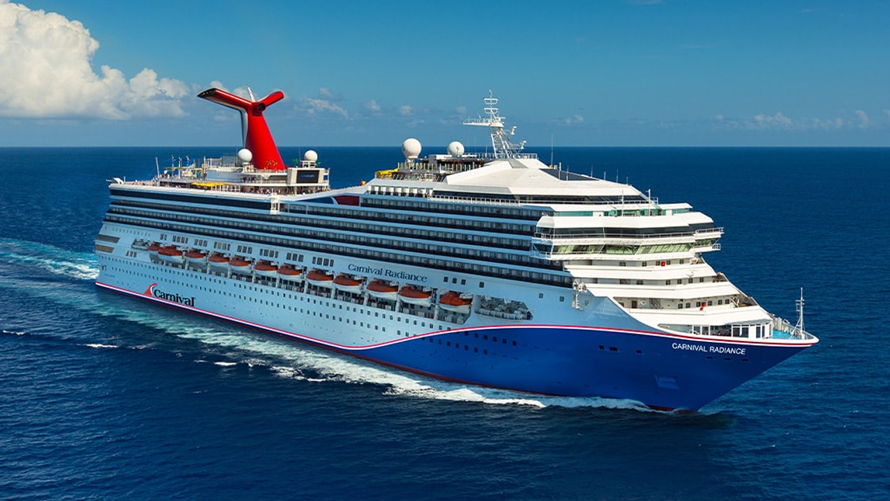 A white and blue Carnival cruise ship in the sea