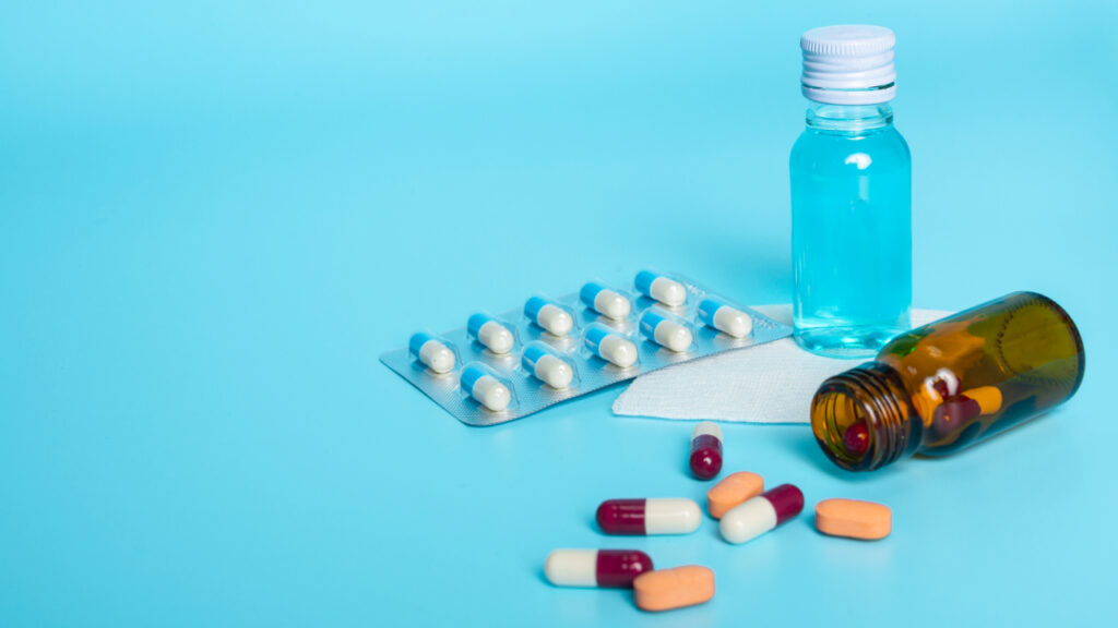 Medicines placed on a blue surface