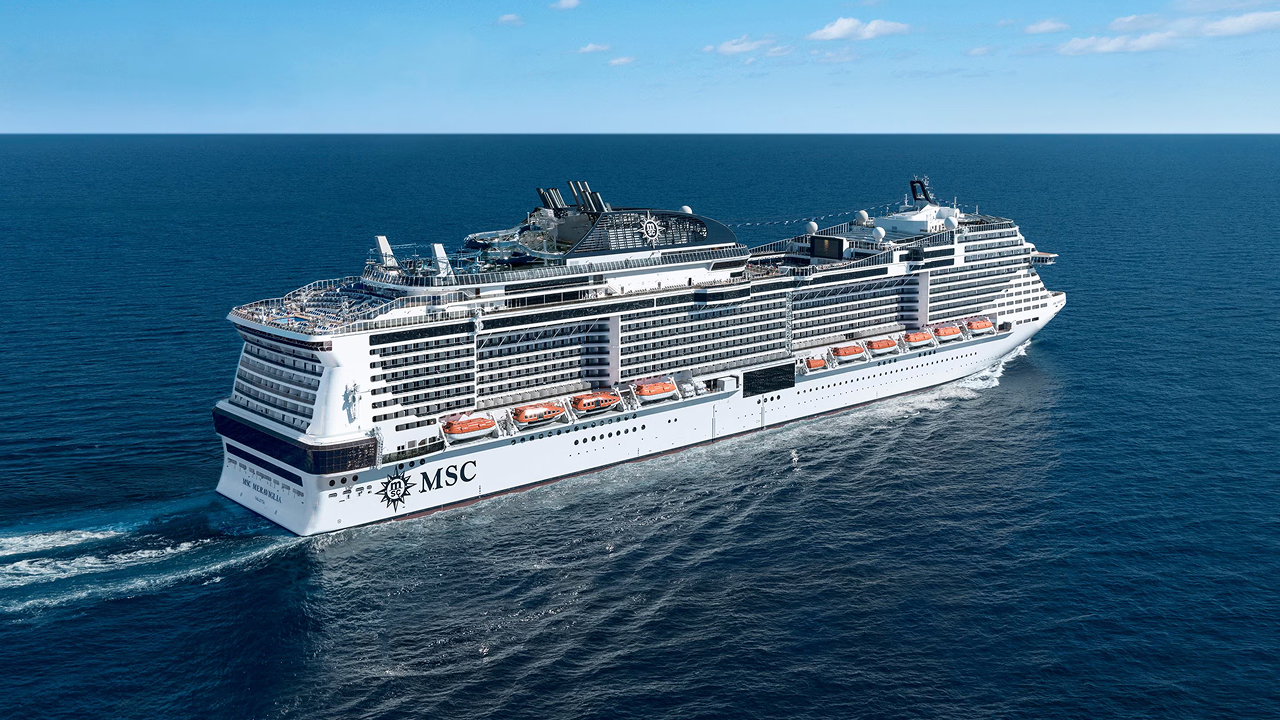 Back view of an MSC cruise ship in a blue sea
