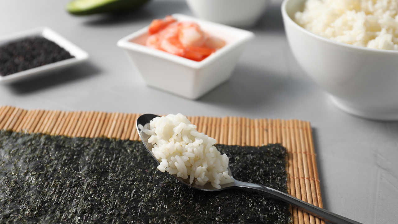 A spoon full of sushi rice