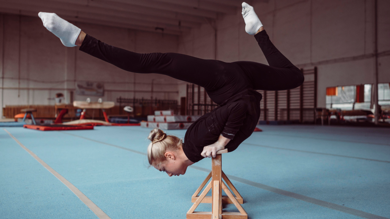A woman training on a wooden piece