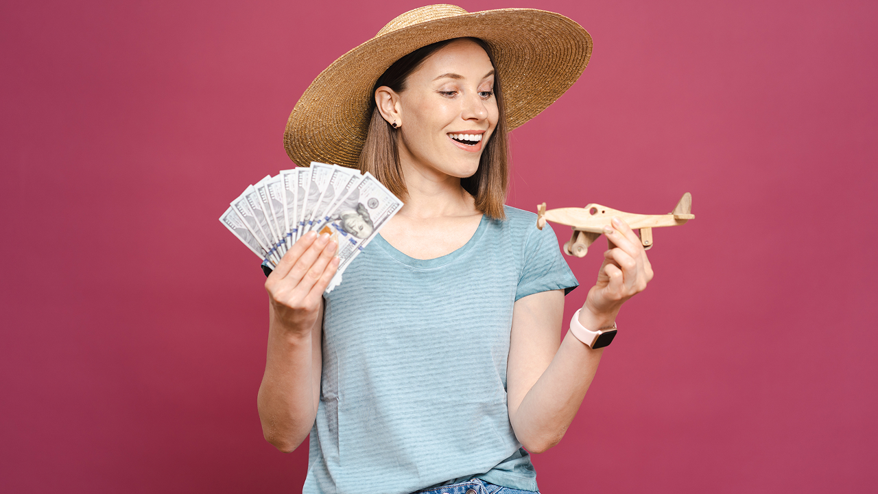 A woman holding money and a wooden plane