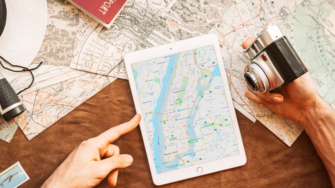 A person with tablet and camera planning for solo travel