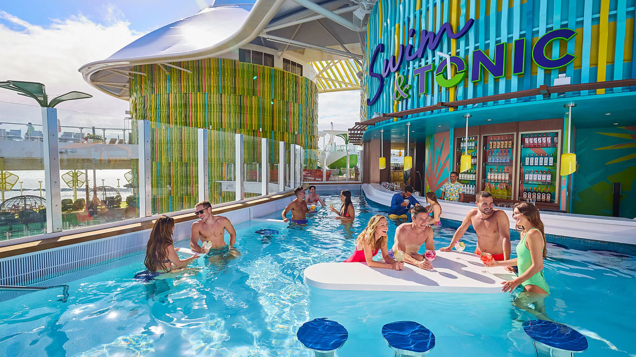 A pool filled with many people enjoying themselves