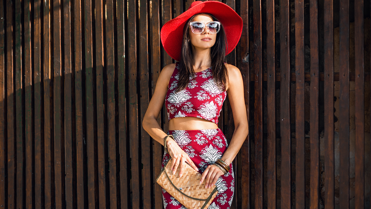 An elegant girl wearing a pink dress, which is one of the perfect cruise outfits